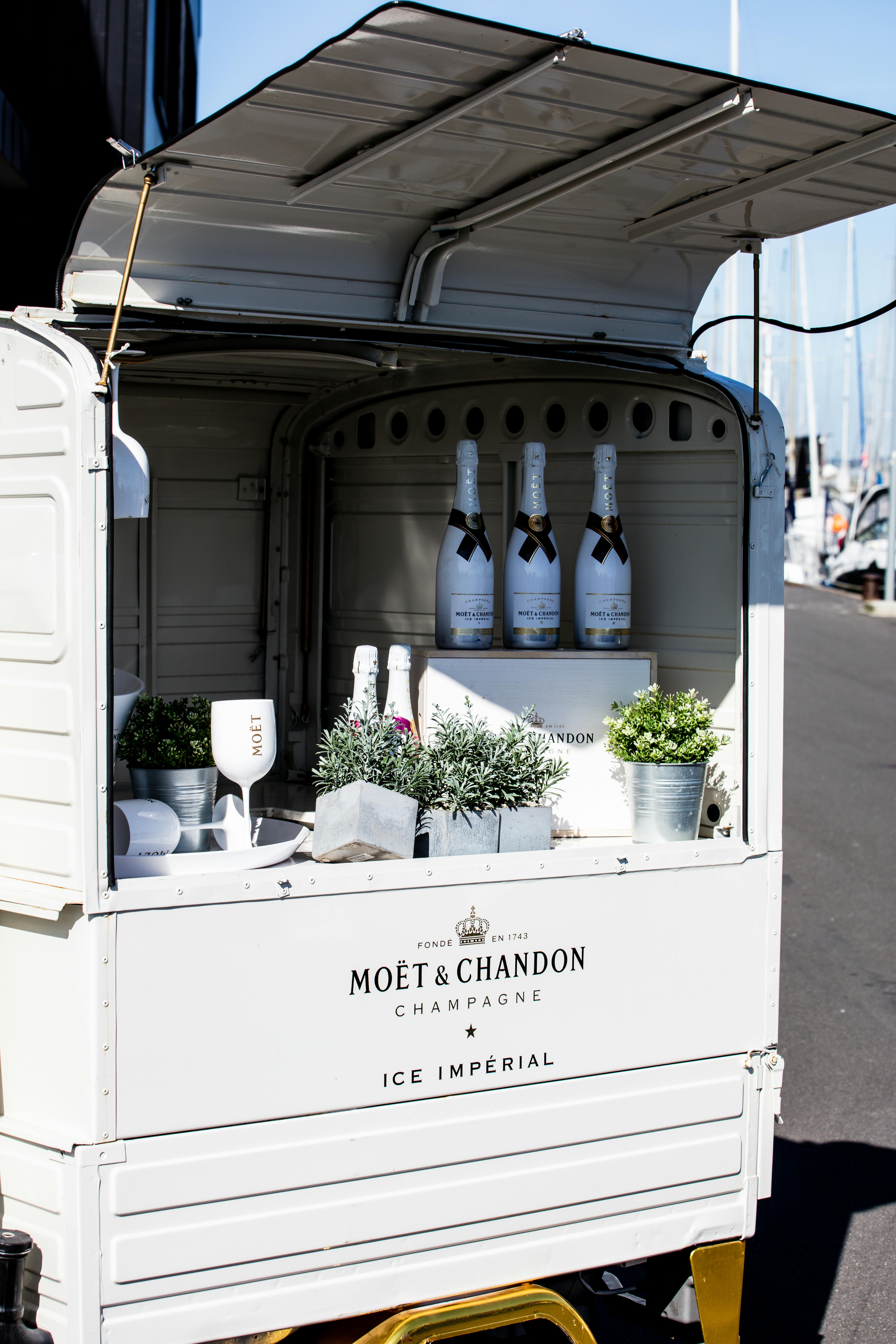 Moët & Chandon champagne bottles displayed in a chic mobile bar outdoors, ideal for celebrations.