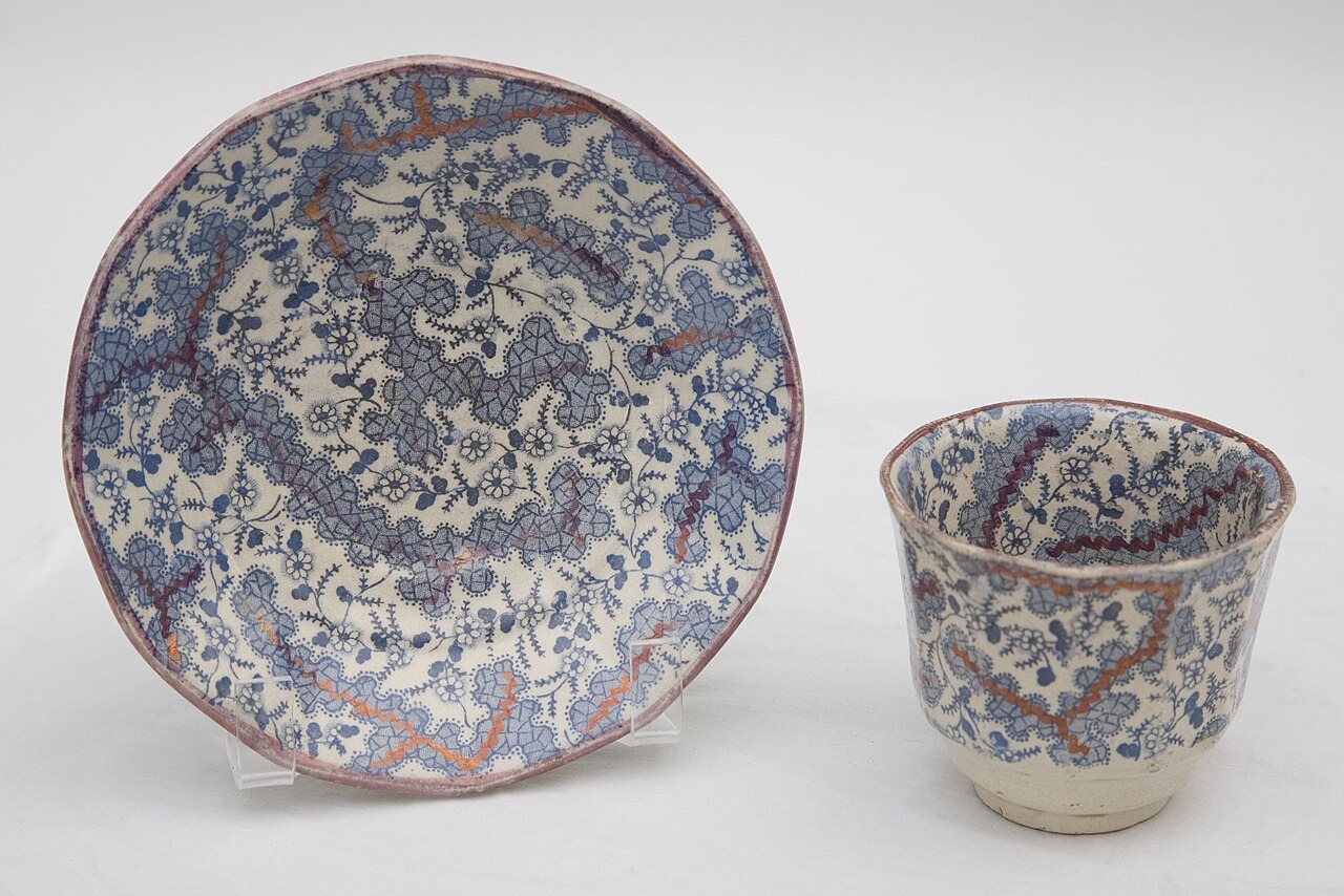 A blue and white patterned teacup and saucer