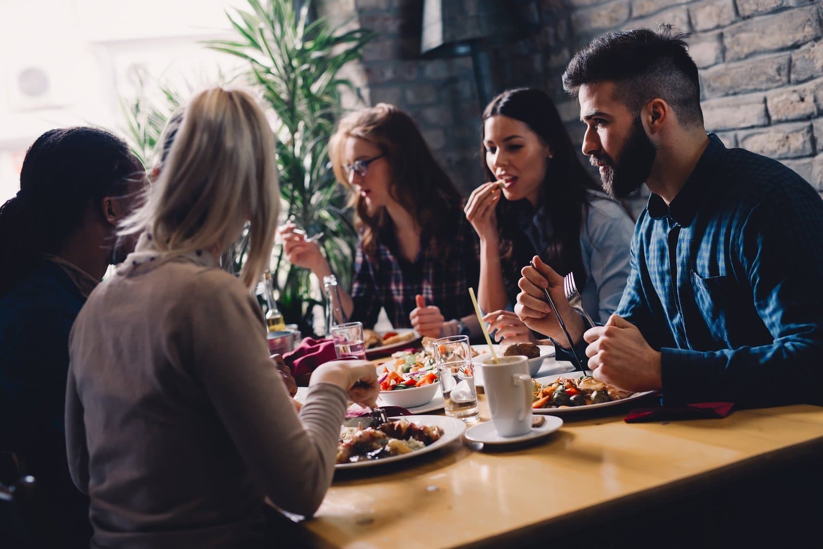 Friends sharing a meal together in community